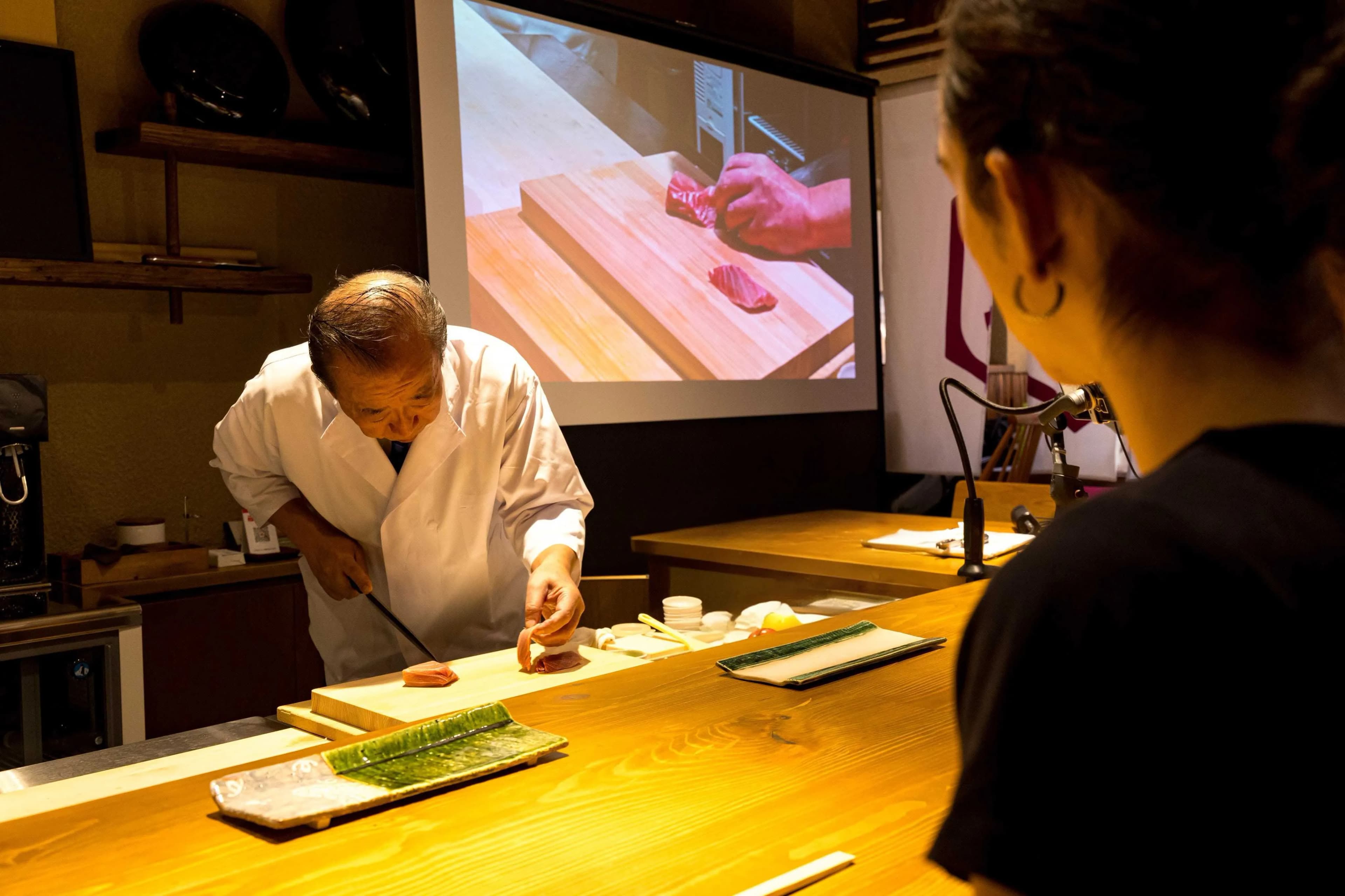 Chef demonstrating traditional knife skills at REONA