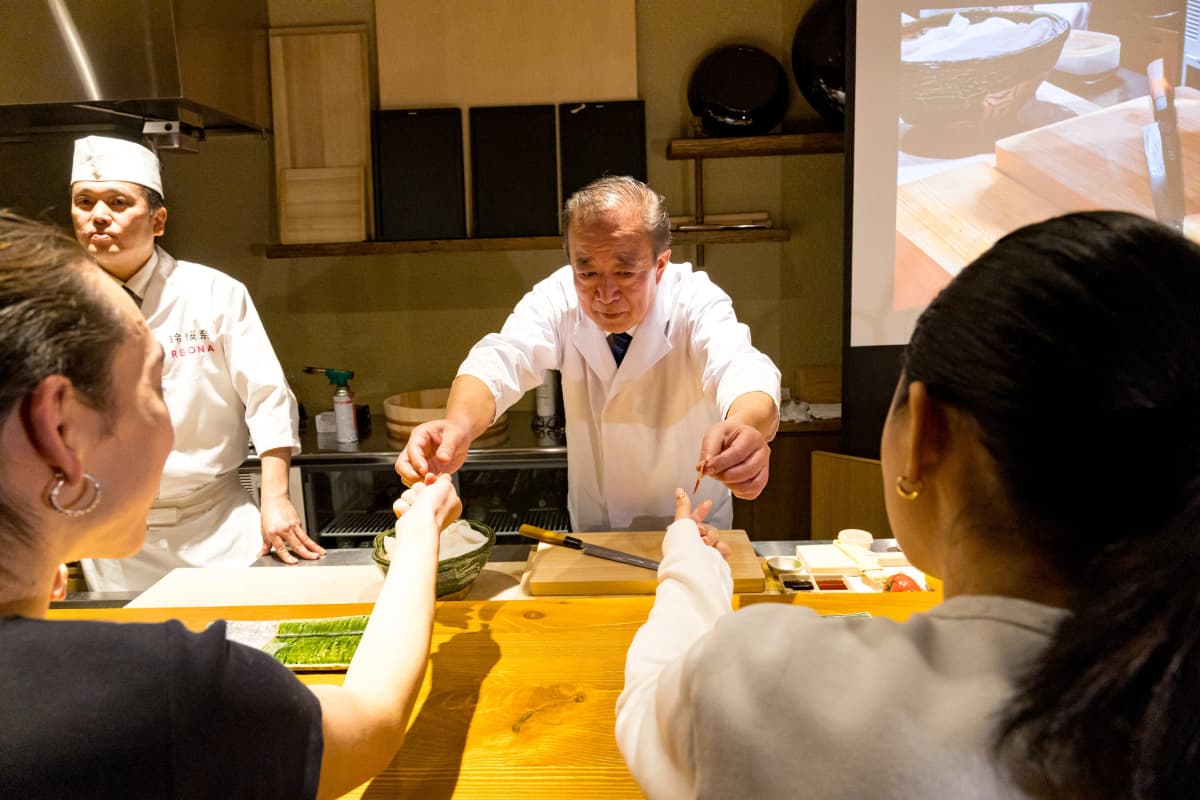 Chef and guest interaction at REONA's intimate sushi counter